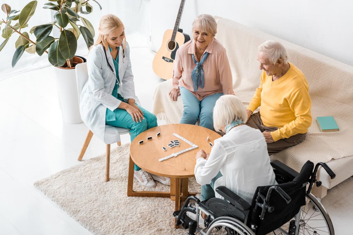 Residents and staff enjoying a game of dominoes